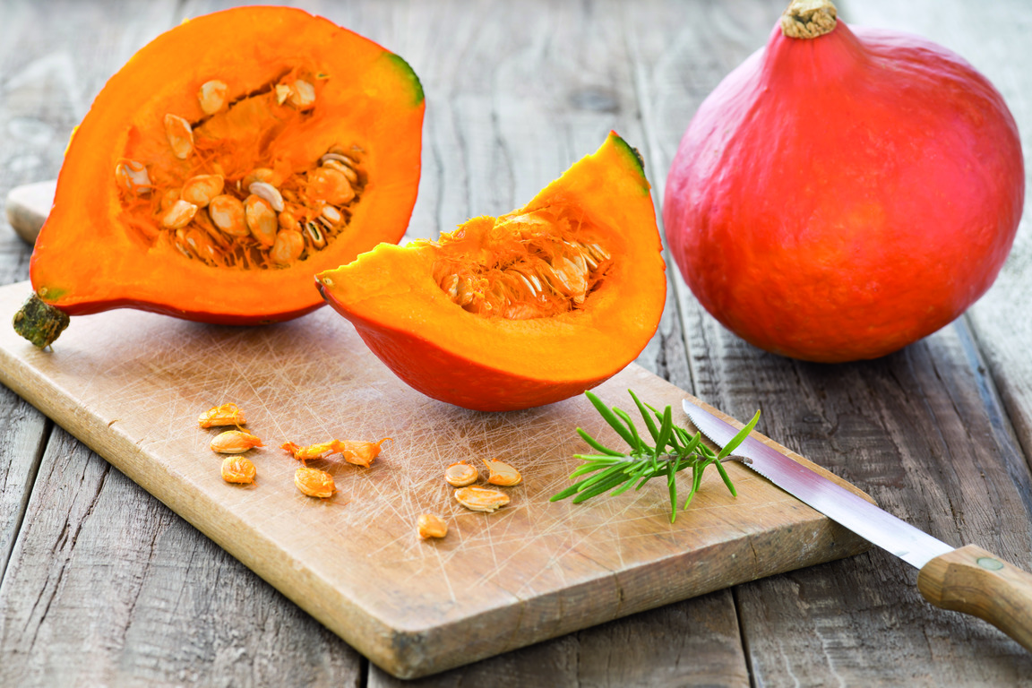 Sliced hokkaido pumpkin on a wooden board