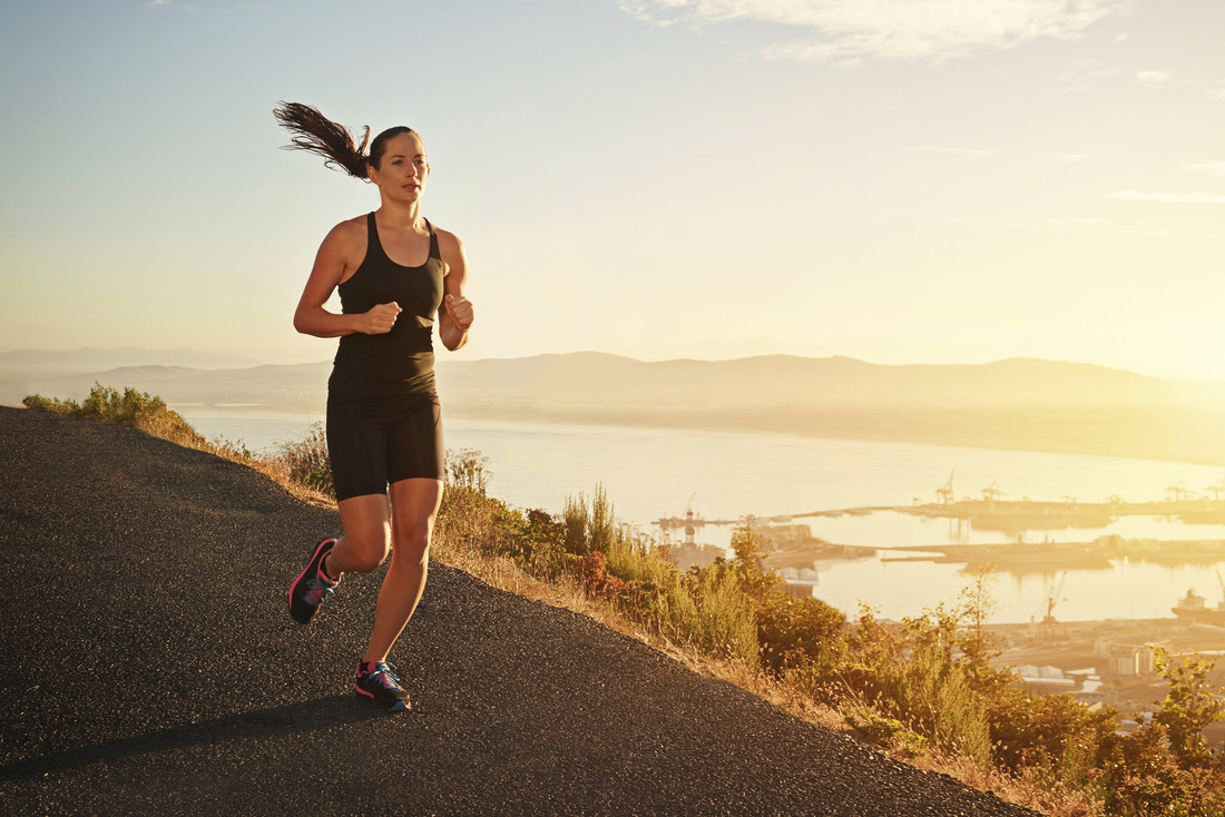 Woman running at sunset