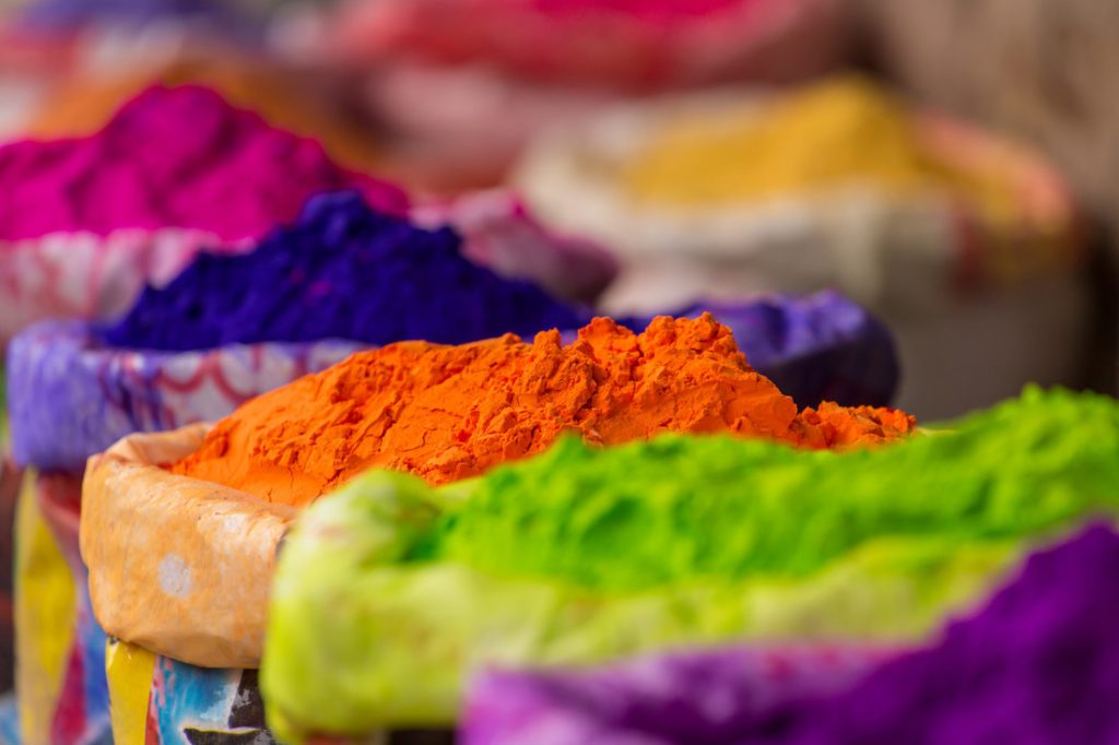 Colorful piles of powdered dyes used for Holi festival in India.