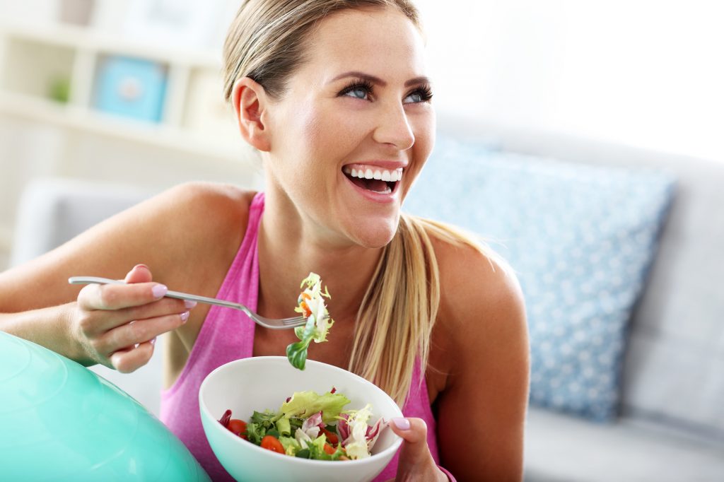 young woman eating a salad suitable for the pegan diet