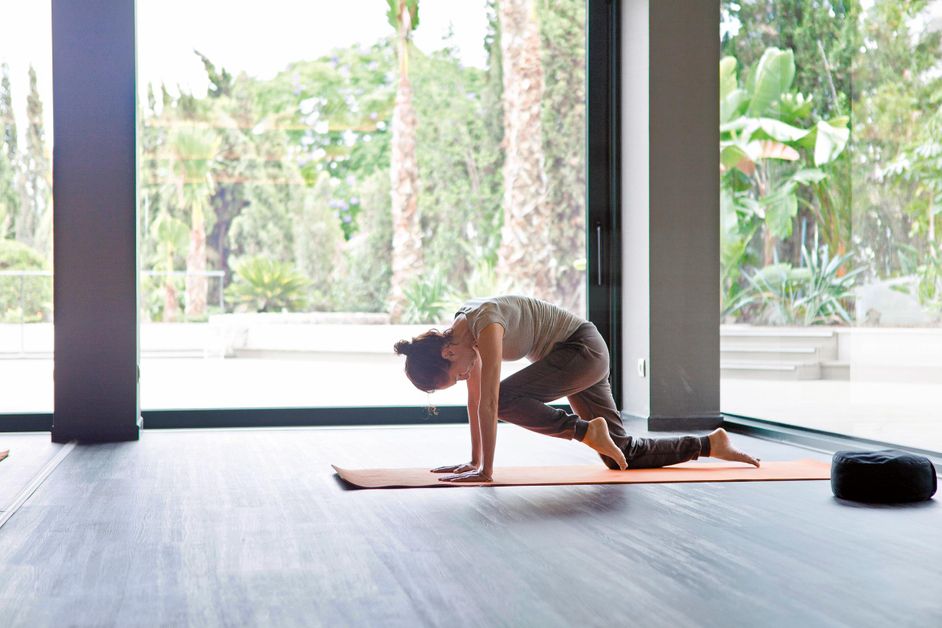 Woman exercising on a yoga mat at the Sha Wellness Clinic