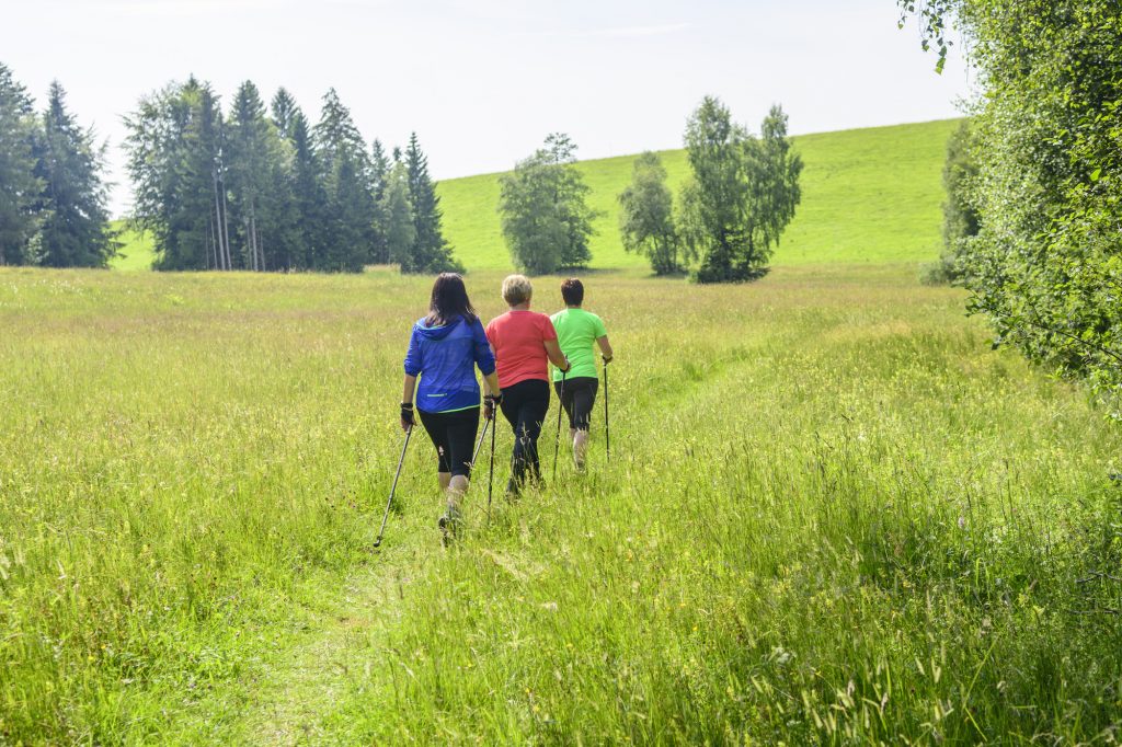 Three women on a fasting hike. Therapeutic fasting with exercise.